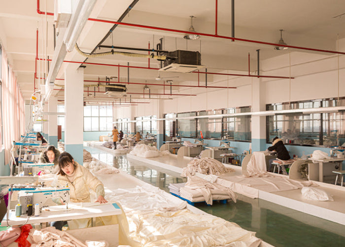 Factory workshop with workers at sewing machines