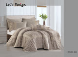 A beige and gray comforter set with matching pillows, bedskirt, and throw pillows displayed on a bed in a bedroom setting.
