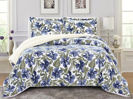A king-sized floral thermal comforter set with blue, white, and green colors, displayed with two pillow shams.