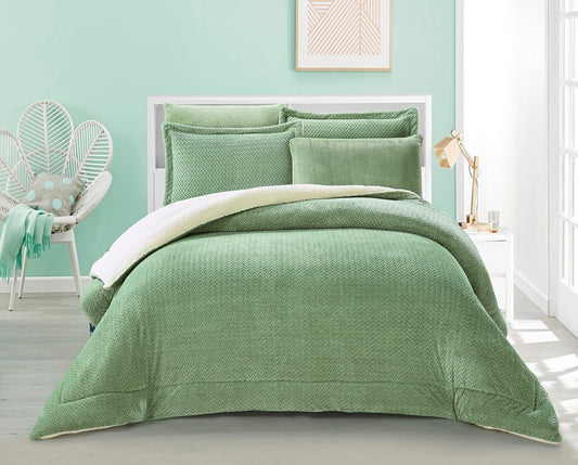 A sage green flannel bedding set on a bed with a white frame, displayed in a room with a chair and a framed picture on the wall.