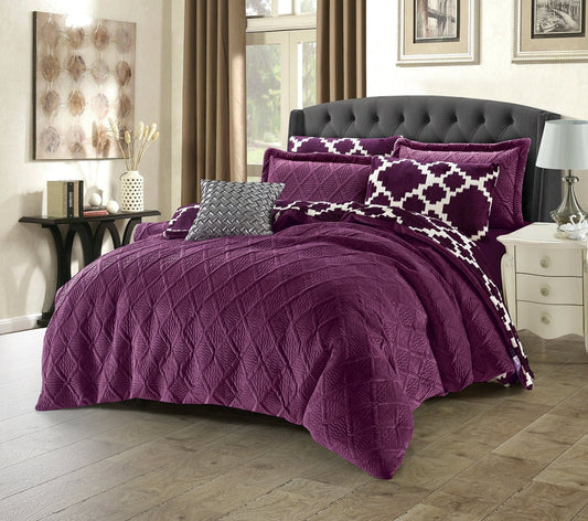 A king-size luxury bedding set in purple with 3D diamond quilting, including two embroidered pillow shams, displayed on a bed.