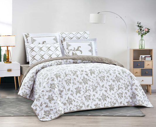 Bed with floral-patterned comforter and pillows in a bedroom setting.
