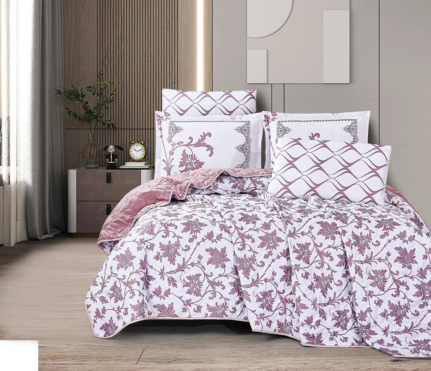 Floral patterned comforter set on a bed in a bedroom setting.