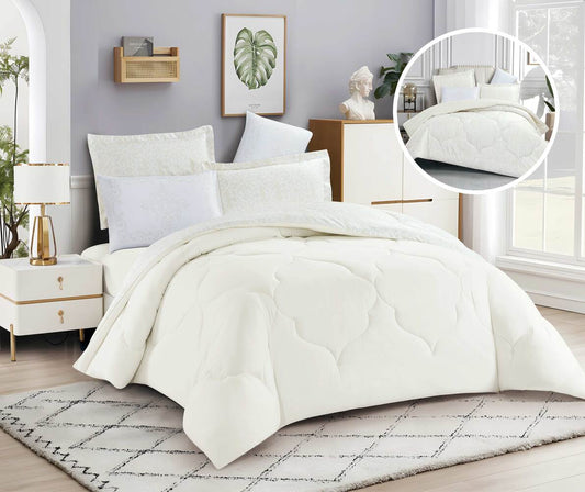 A white classic quilted comforter set displayed on a bed, with a close-up inset showing the texture of the comforter.