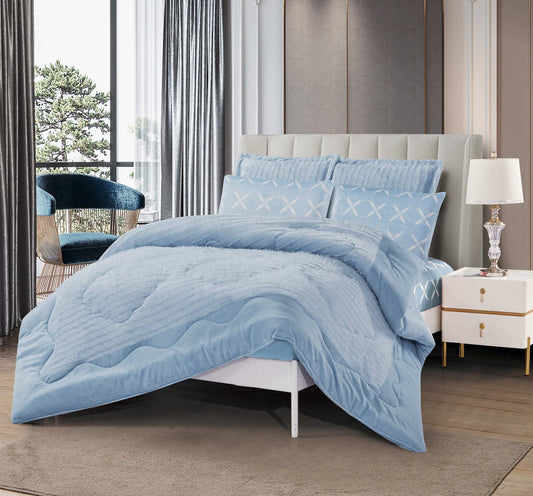 A sky blue cutwork quilted bedding set on a bed, with a matching pillow and comforter, in a room with a window and a lamp.