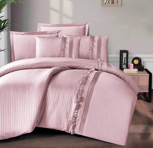 A pink lace trim summer comforter set with matching pillows and comforter, displayed in a bedroom setting.