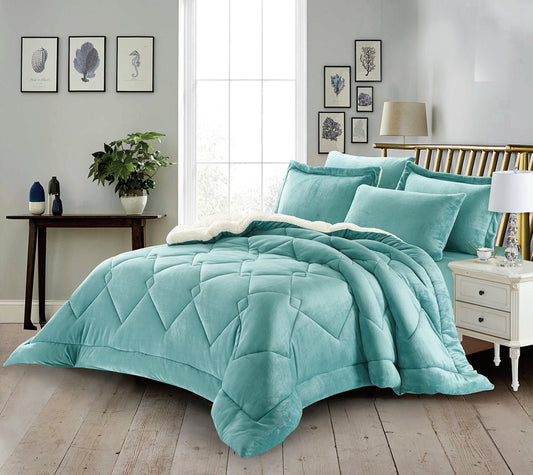 A luxury blue quilted comforter set displayed on a bed, with additional details such as a satin pillow sham and a quilted coverlet on the foot of the bed.