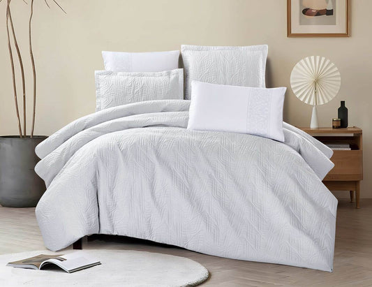 A white comforter set with striped pattern displayed on a bed, accompanied by matching pillows and a bedsheet, in a room setting with decor.