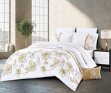 A white bedding set with gold rose patterns displayed on a bed, including a comforter, bed sheets, and pillowcases.