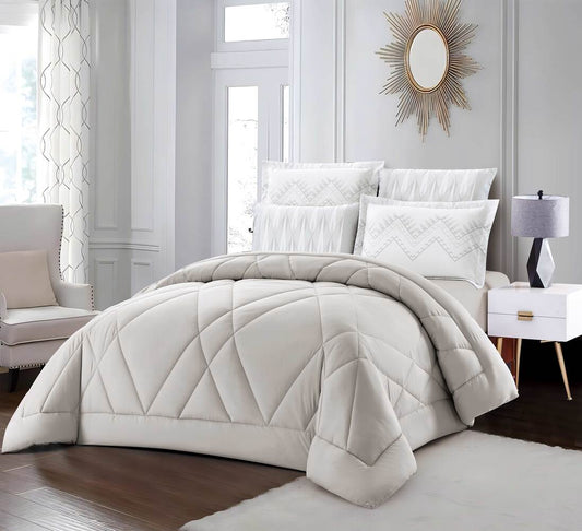 A quilted summer comforter set in beige color, displayed on a bed with matching pillows and bedsheet, in a bedroom setting.