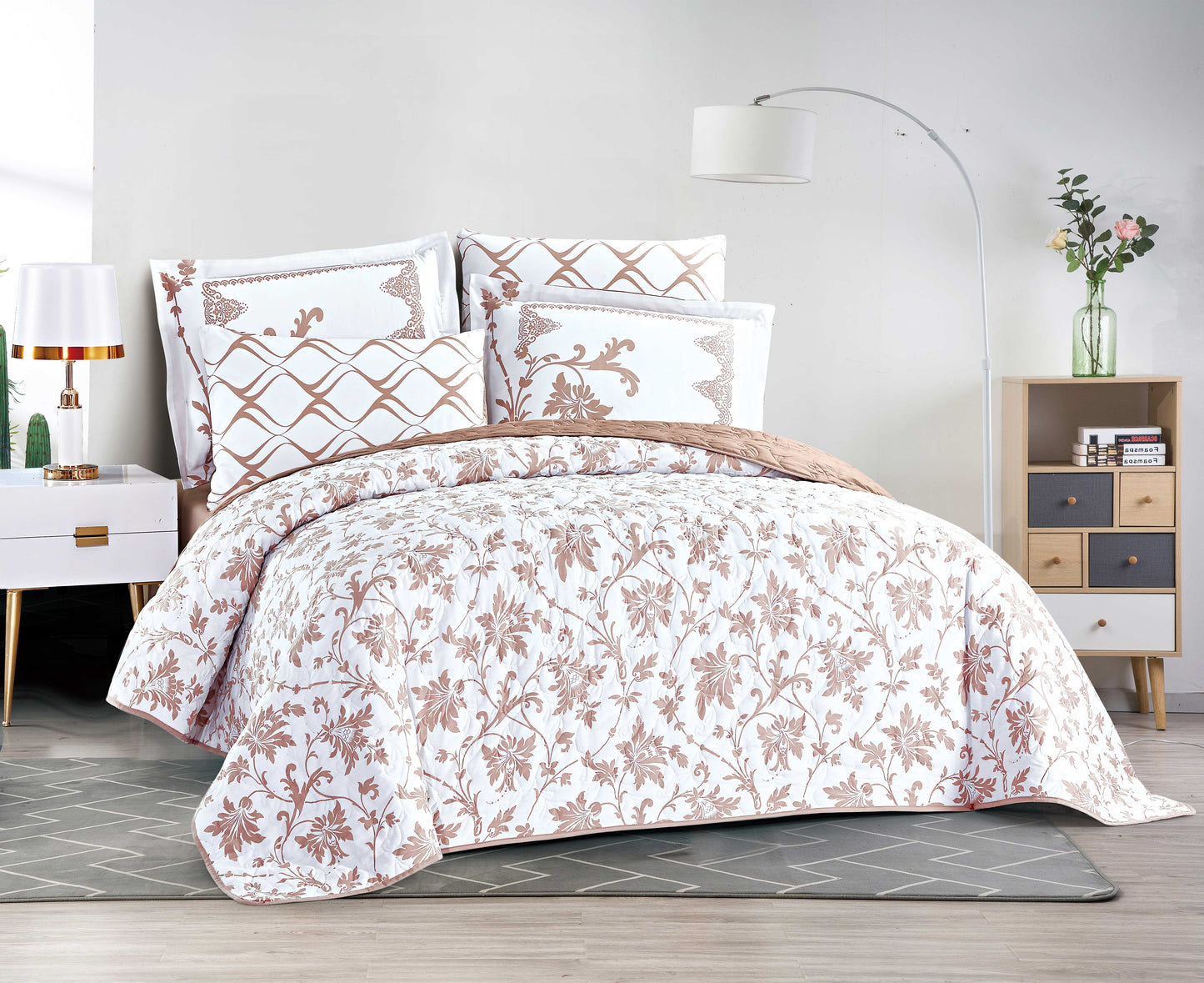 Floral patterned comforter set on a bed in a bedroom setting
