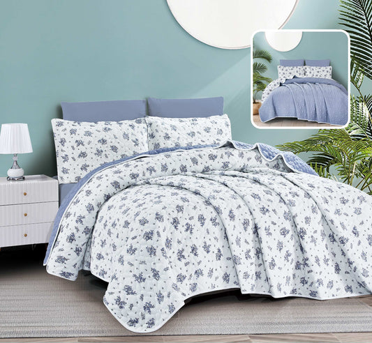 Floral bedding set on a bed with a nightstand and lamp in the background.