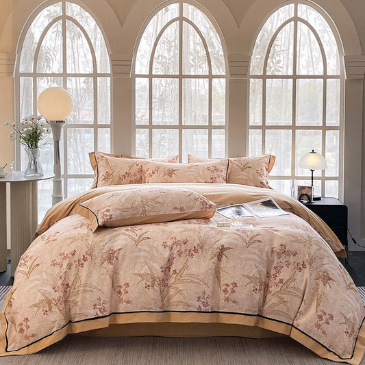 A luxury cotton fitted duvet cover set with floral patterns, displayed on a bed in a room with arched windows.