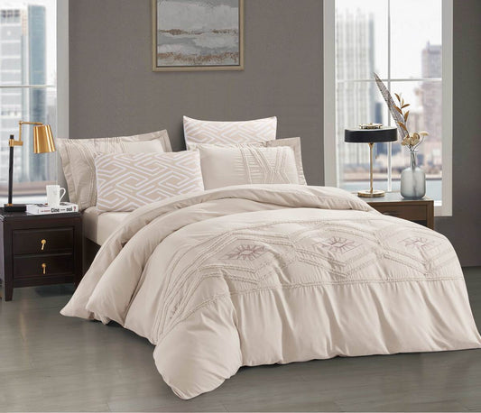 A beige comforter set with embossed cut-out floral pattern displayed in a bedroom setting.