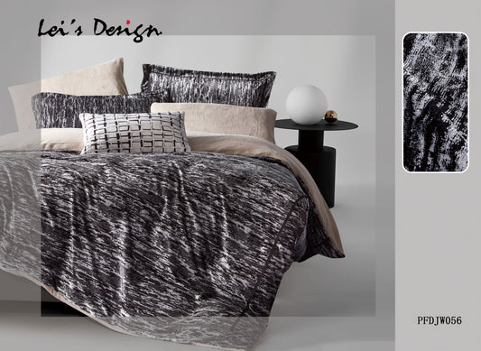 A bedroom scene with a black and white comforter set on the bed, along with matching pillows, bed sheets, and a decorative lamp.