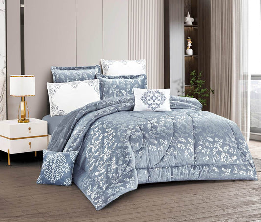 A gray quilted lace-trimmed comforter set displayed on a bed, with additional pillows and bedding accents in a matching gray color scheme.