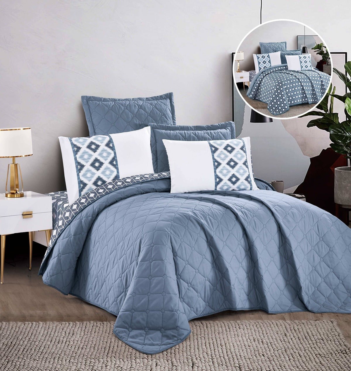 A blue bedspread with a solid pattern displayed on a bed, accompanied by matching pillows with decorative patterns.
