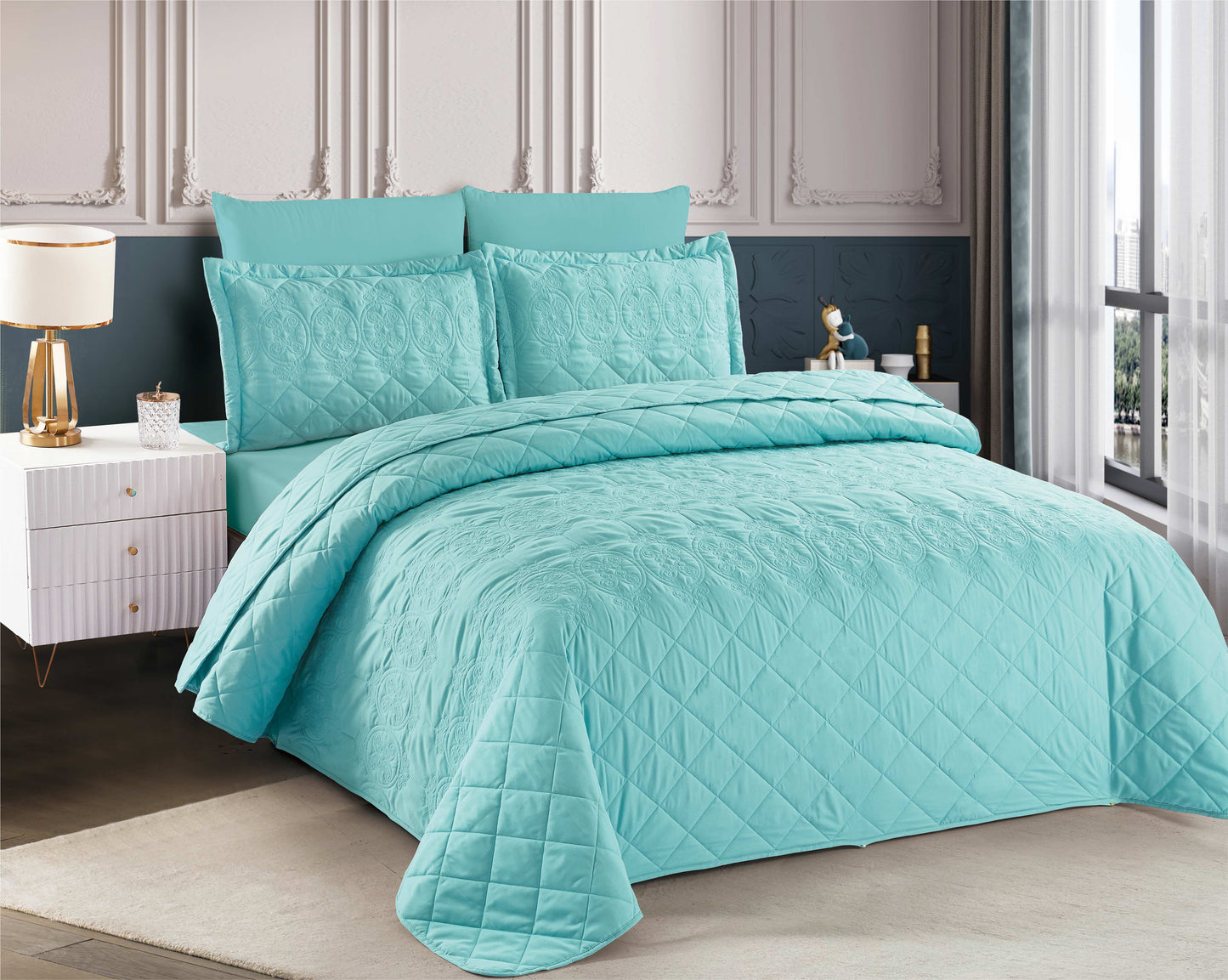 Turquoise quilt set on a bed in a bedroom setting