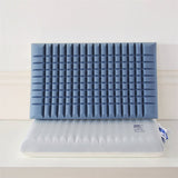 A blue memory foam pillow with a double layer carved design, displayed alongside its packaging.