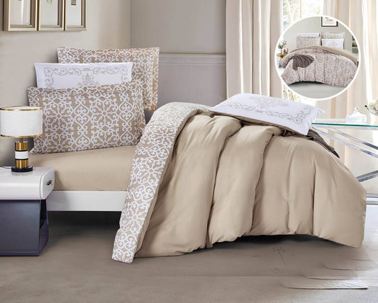 A beige and floral comforter set on a bed, with a pillow featuring a beige solid color on one side and a floral pattern on the other, displayed in a well-lit room with curtains and a book on the bed.
