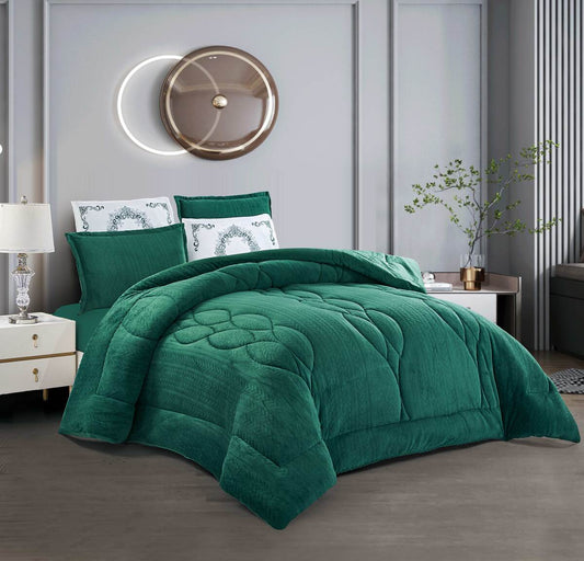 A dark green oval-quilted flannel comforter set on a bed, with two pillow shams, in a room with a decorative lighting fixture above the bed.