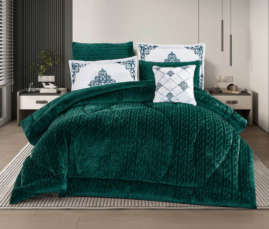 A forest green striped quilted comforter set on a bed, with two white pillows featuring a blue geometric pattern, in a room with a white and gray decor.
