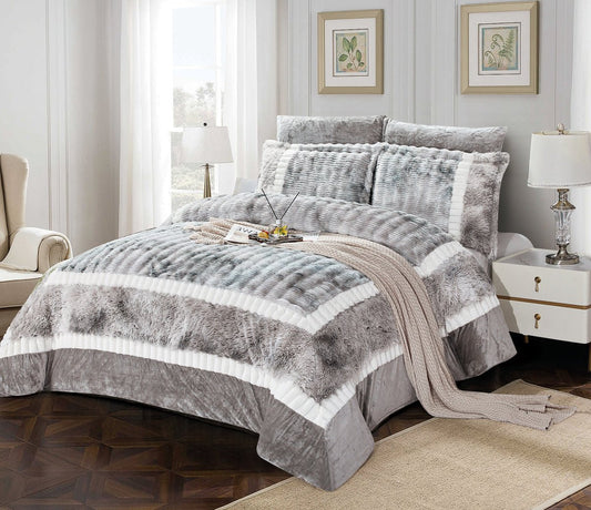 A king-size comforter set with a colorblock flannel design in gray and white, displayed on a bed with additional pillows and a duvet cover.
