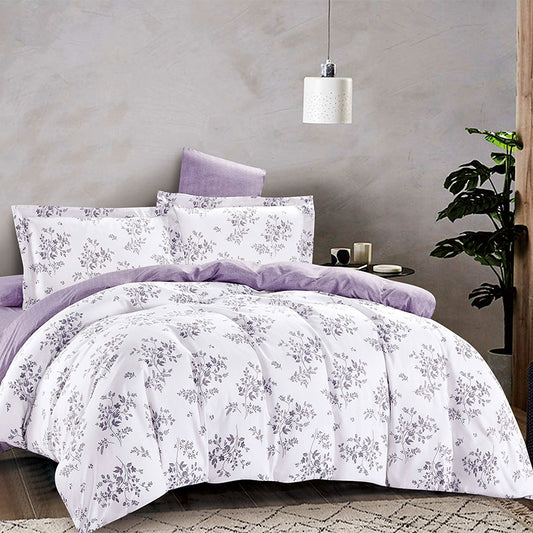 Floral patterned comforter set with purple accents on a bed in a bedroom setting.