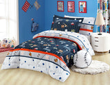 A quilted bedding set with a sports ball theme, displayed in a bedroom setting. The set includes a comforter, pillows, and bed sheets with a design that features various sports balls and a striped pattern.