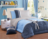 A bedding set with color-blocking design in blue and white, featuring a bowknot decoration, displayed in a bedroom setting.