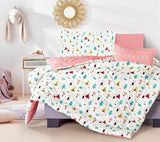 A bedding set with a white background featuring a geometric pattern with multicolored triangles and polar bears in a bedroom setting.