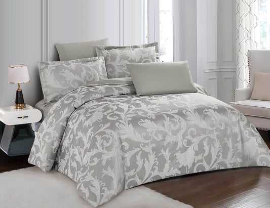 A gray bedding set with floral patterns, including a duvet cover and pillows, displayed on a bed.