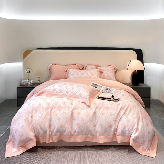 A pink Tencel duvet cover set on a bed with a book and a remote control on the bed's footboard, placed in a room with a modern decor.