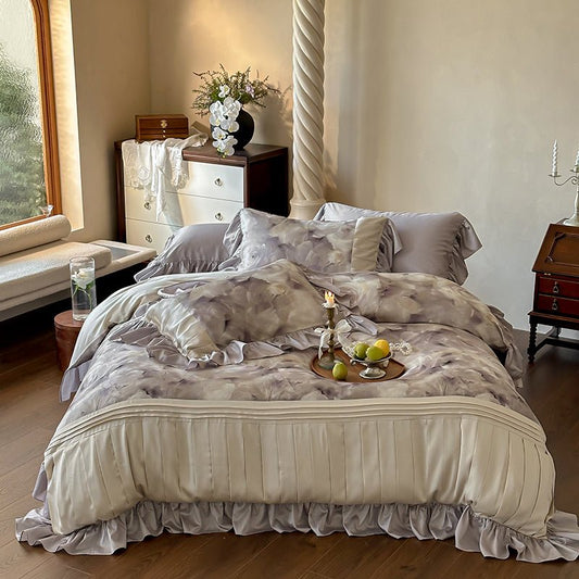A bedding set with a floral lace print, displayed on a bed in a bedroom setting, with additional decorative objects like a vase and fruits on the bed.