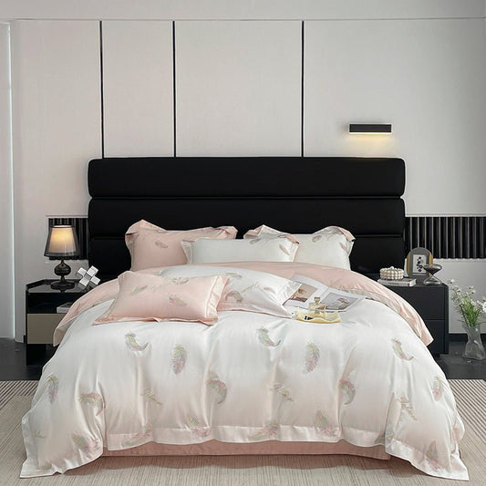 A luxury cotton duvet cover set in a model bedroom, featuring a white and pink color scheme with a floral pattern, displayed on a bed with a black headboard.