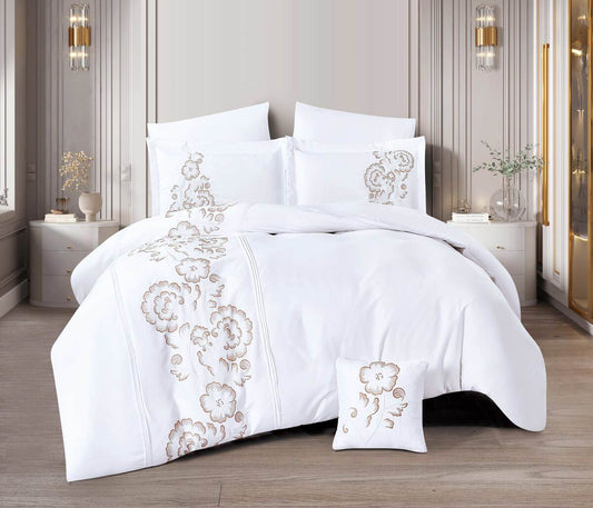 A white bedding set with printed floral designs, displayed in a room setting with elegant interior decor.