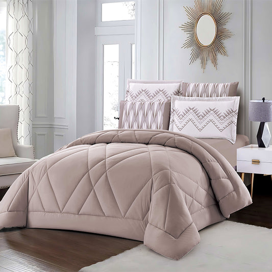 Beige quilted comforter set on a bed in a stylish bedroom with geometric pillows and a mirror.