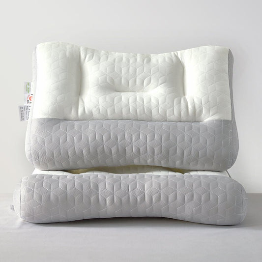 A stack of white and gray zoned latex pillows with textured surfaces.