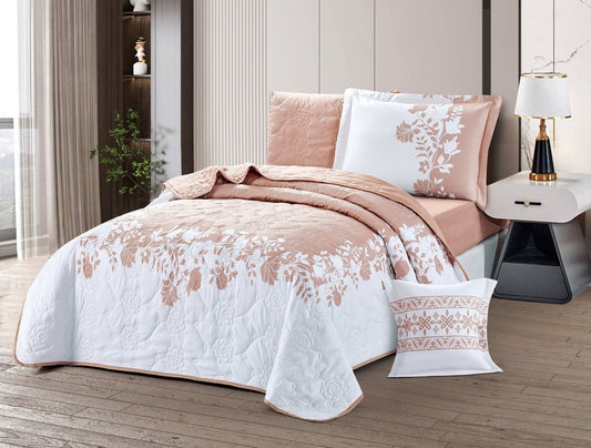A bedspread in pink and white with a geometric pattern, displayed on a bed in a room with modern decor.
