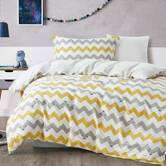 Bed with yellow and gray chevron patterned bedding in a room setting.