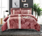 A color block comforter set in red and white, displayed on a bed with additional decorative pillows and a plant in the background.