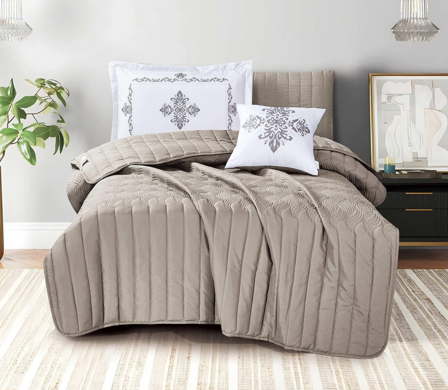 Quilted brown comforter set on a bed with decorative pillows in a bedroom setting.