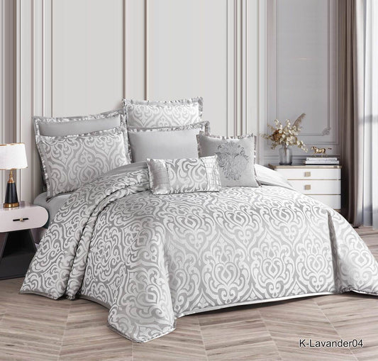 A glossy gray floral bedding set displayed on a bed, with matching pillows and comforter.