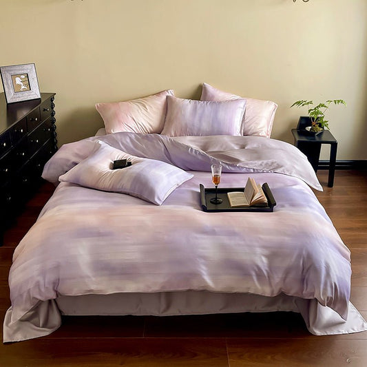 A duvet cover set with a minimalist cloud design, displayed in a bedroom setting with pillows, bed, and a side table.