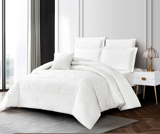 A white floral summer bedding set displayed on a bed, with a comforter, bedsheet, and pillows.