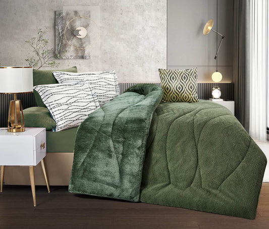A forest green ombre quilted comforter set on a bed, with additional details such as pillows and room decor visible in the background.