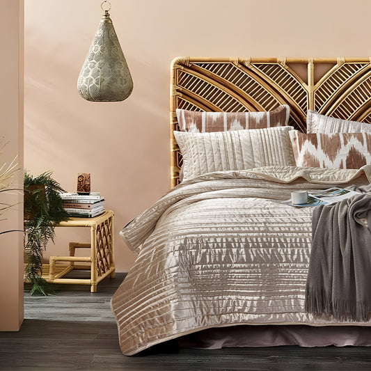 Bedroom with a bed featuring patterned bedding and pillows, wooden headboard, and side table.