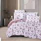 Floral patterned comforter set on a bed in a bedroom setting.