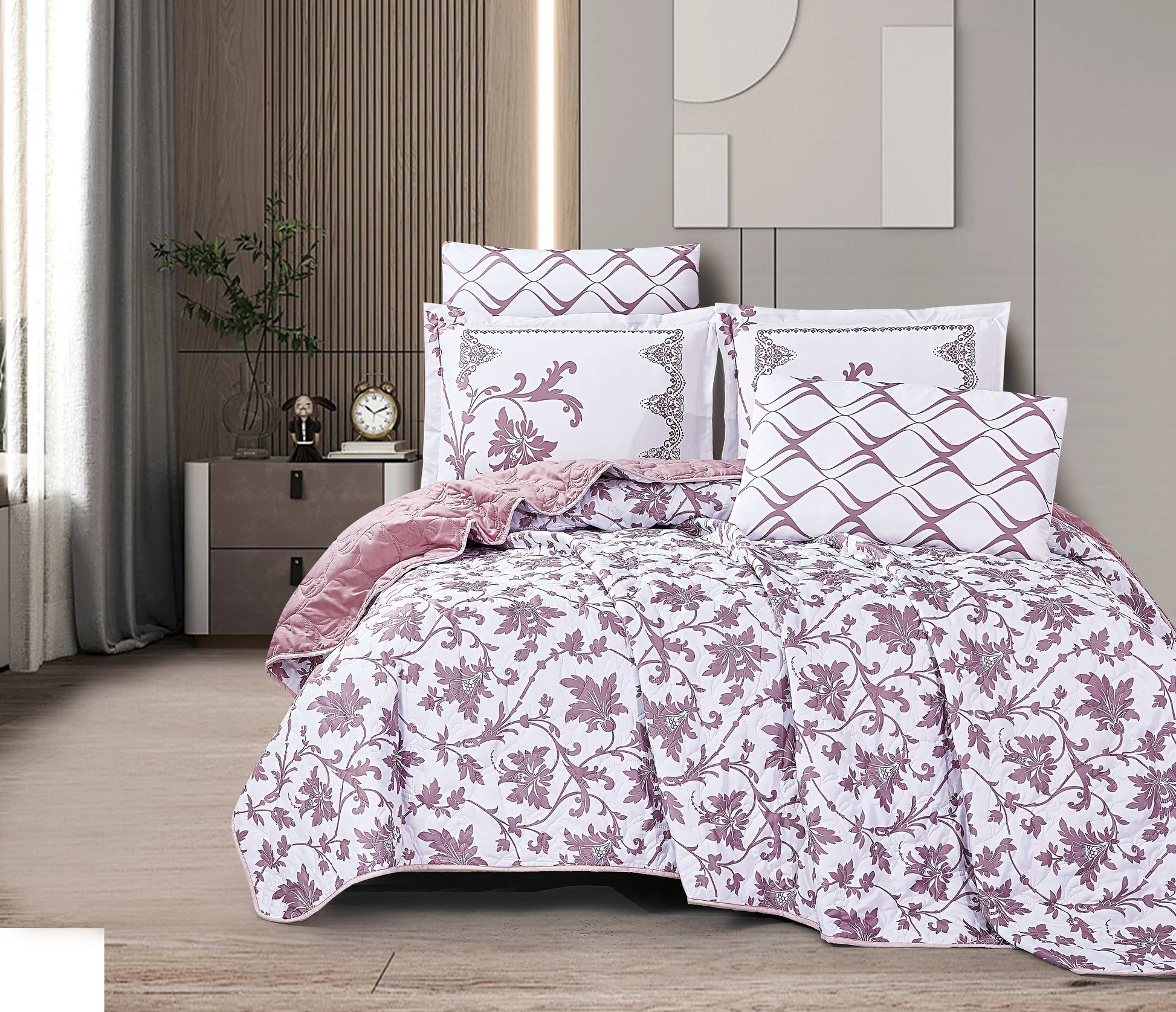 Floral patterned comforter set on a bed in a bedroom setting.