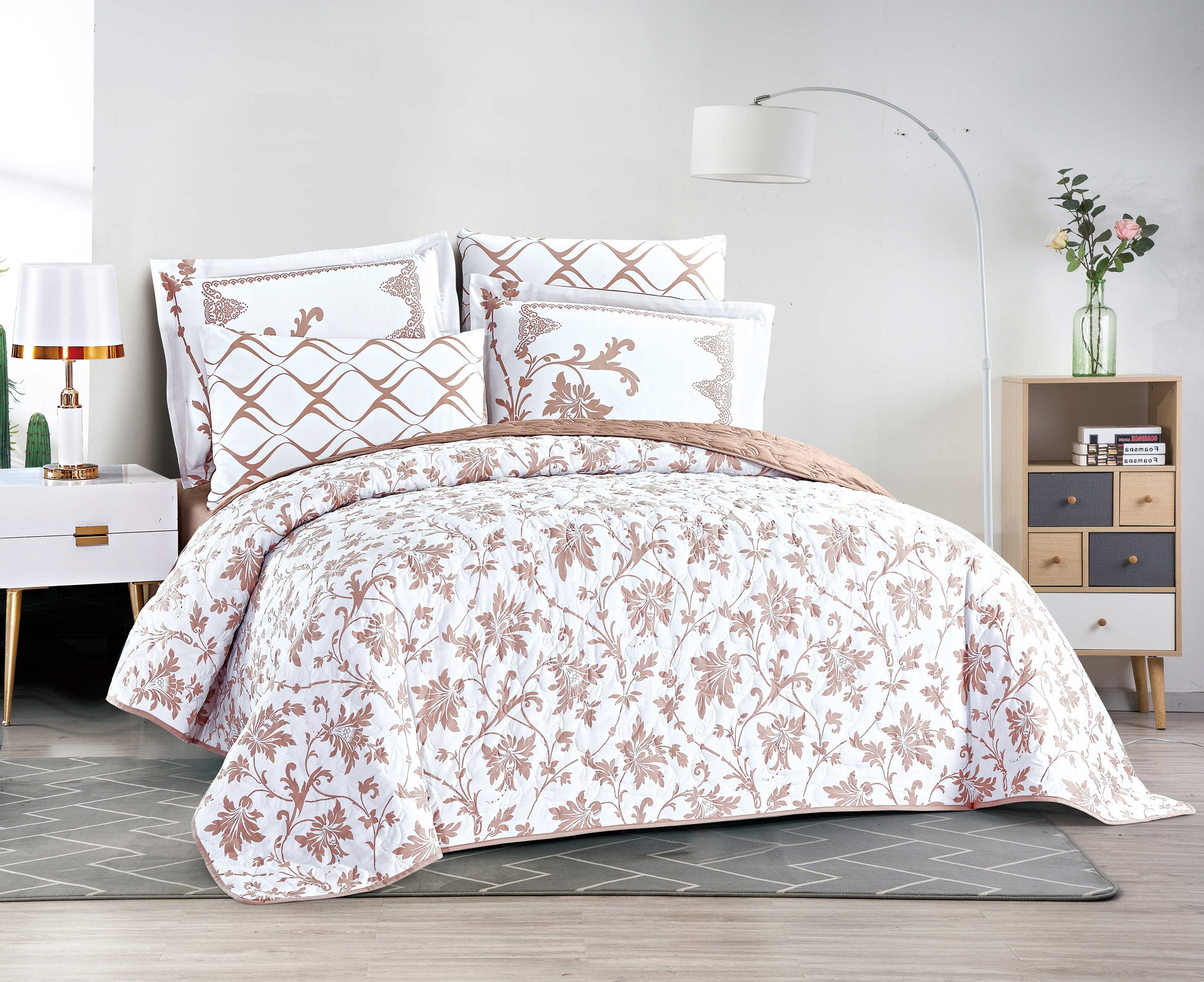 Floral patterned comforter set on a bed in a bedroom setting